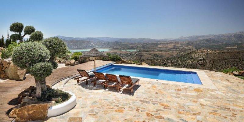 Poolside sunbeds with mountain views in Andalucia