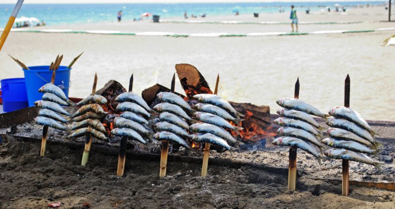 Sardines being cooked on the beach