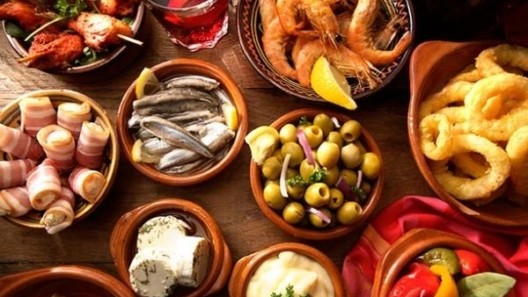 typical tapas dishes in earthenware bowls