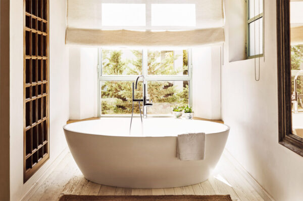 Large freestanding bathtub with garden view